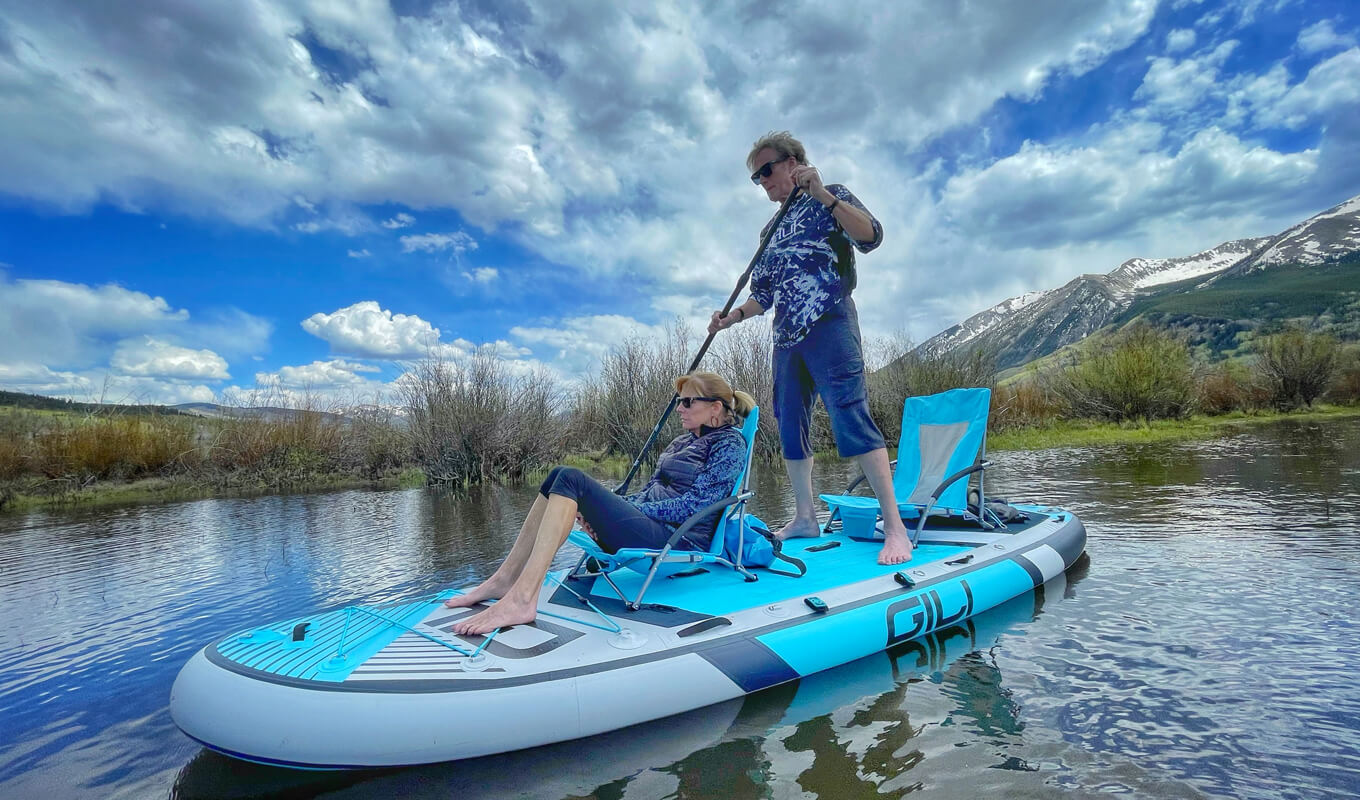 Man and a woman paddle boarding on a manta board