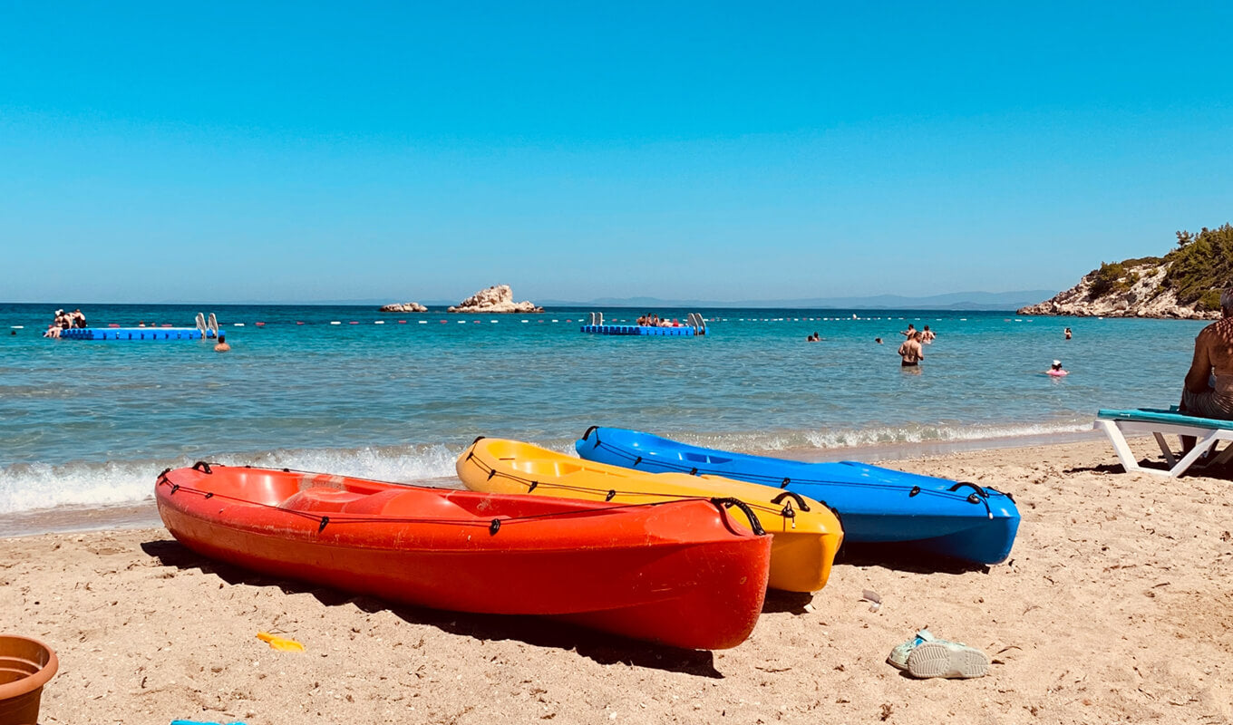 Three kayak on a different color on a beach