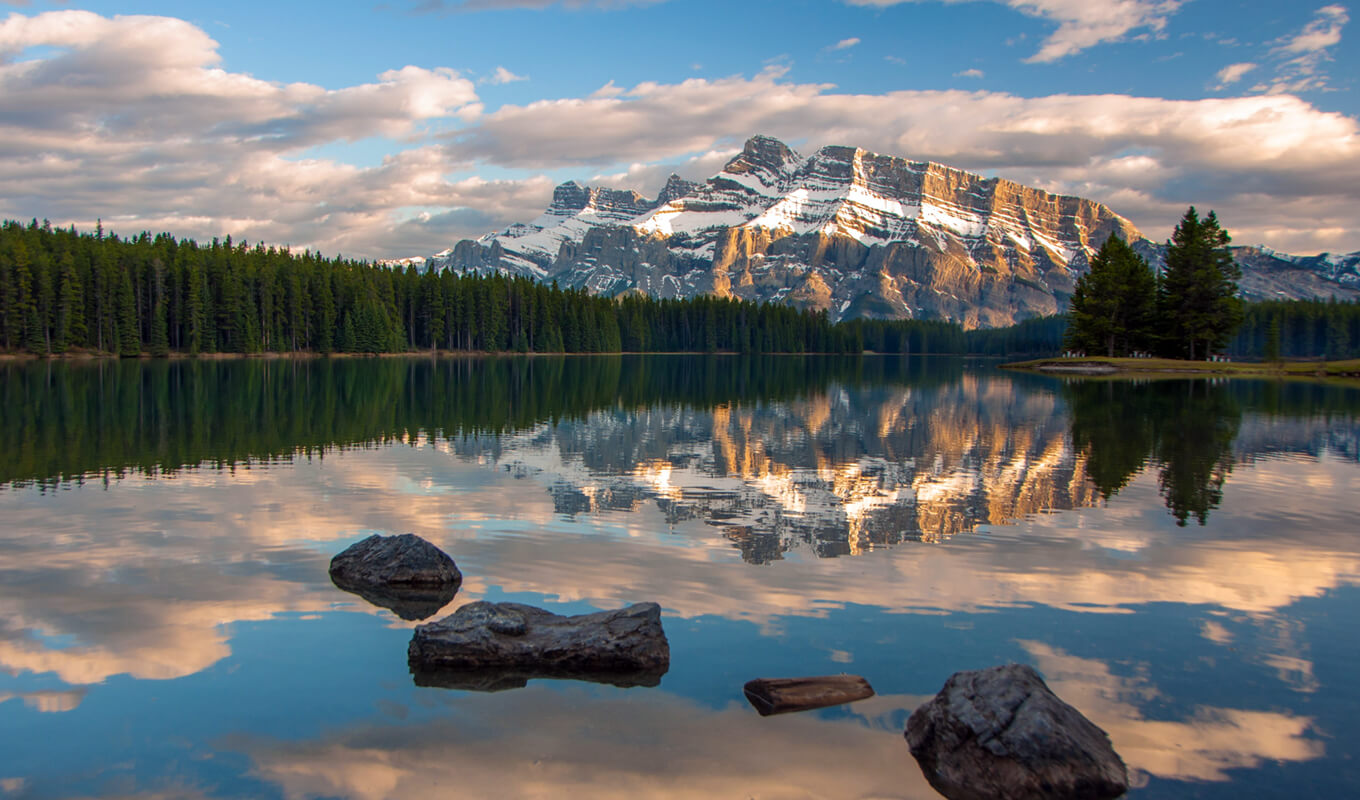 Two Jack lake with snow mountain and water reflection in Banff National Park