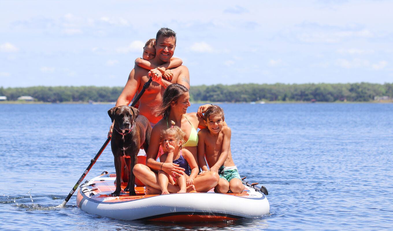 Family paddle boarding on a swimwear