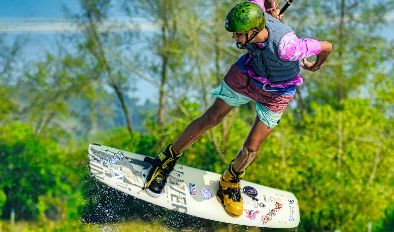 Man wakeboarding using a gray life jacket