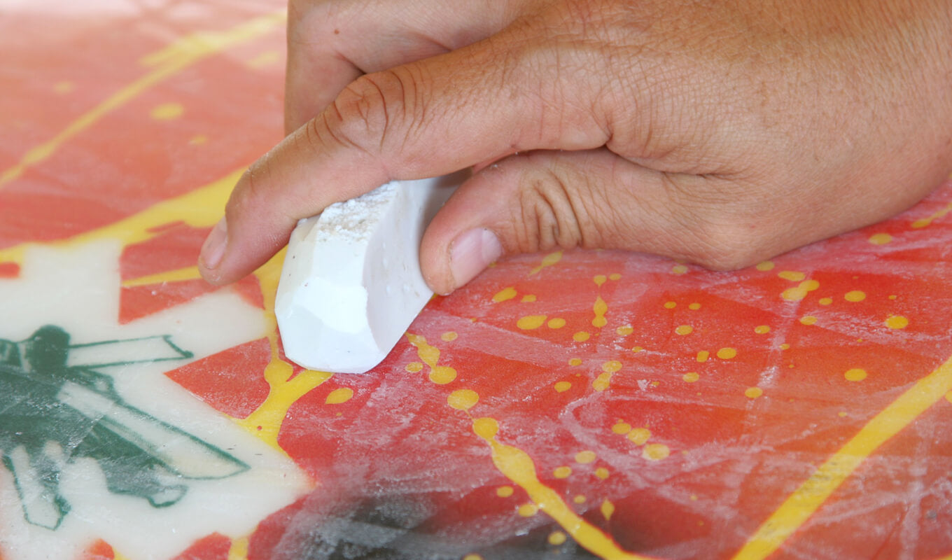 Waxing a surfboard