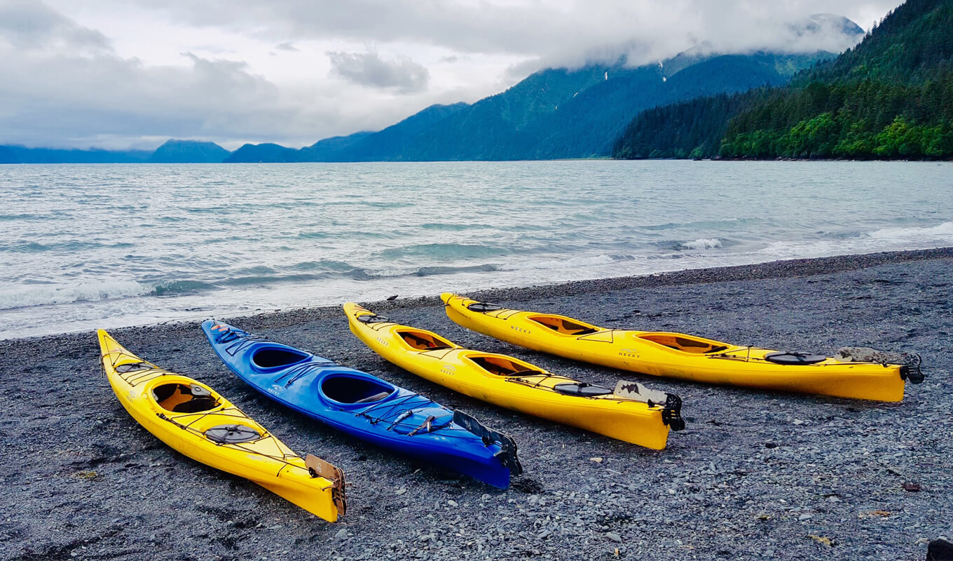 Blue and yellow kayak on a seashore