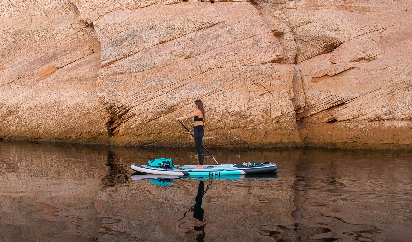 Woman paddle boarding in antelope canyon with an air sup