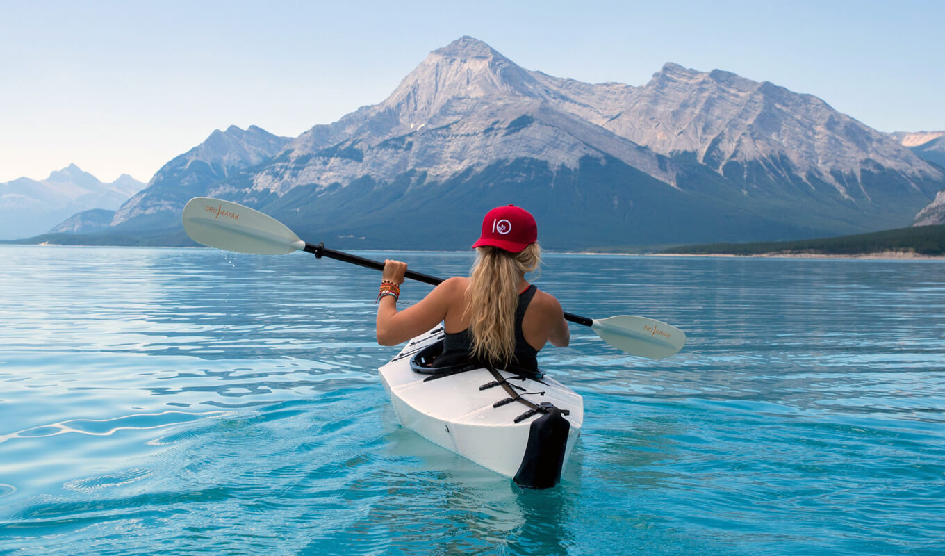 Woman on a white kayak practicing forward stroke