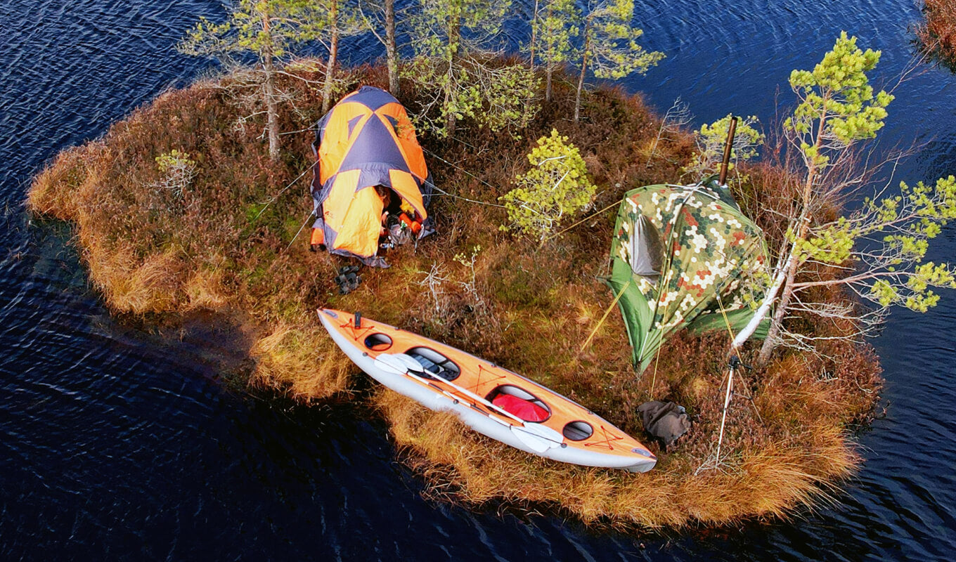 Kayak and camping tent setup on an island