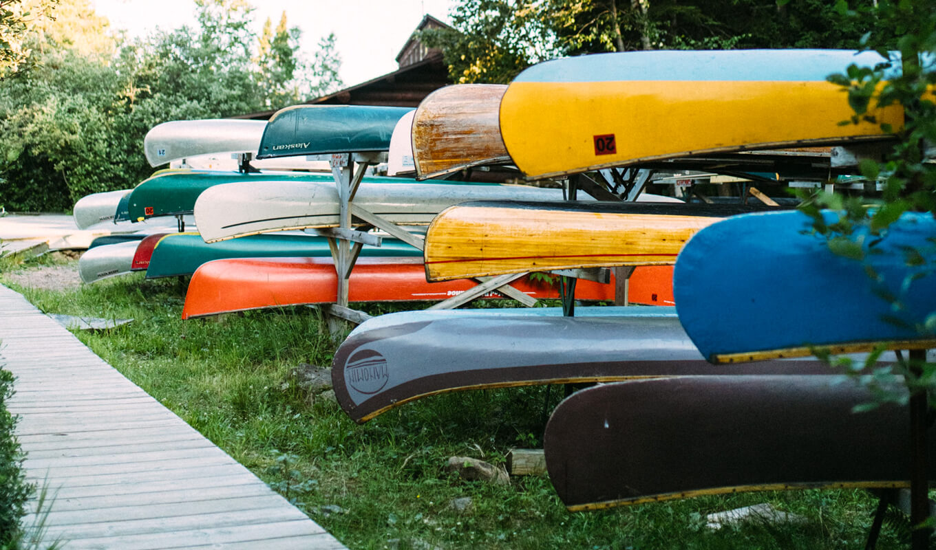 Canoe with different sizes and color on a rack