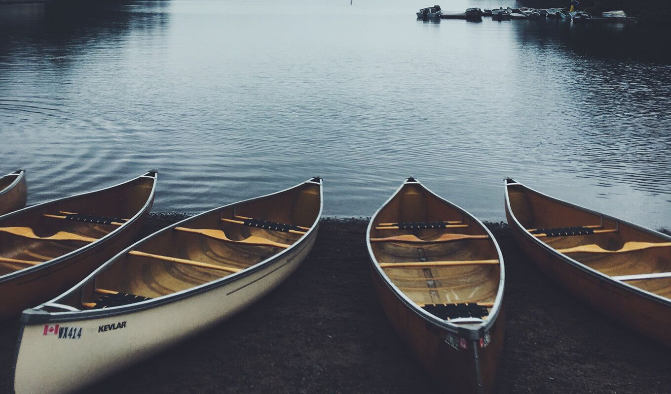 Canoes on the side of the lake