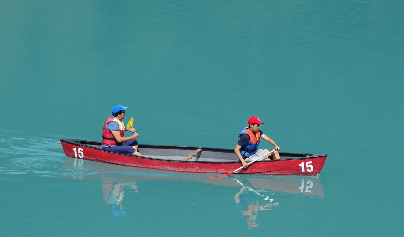 Man and a woman on a red canoe