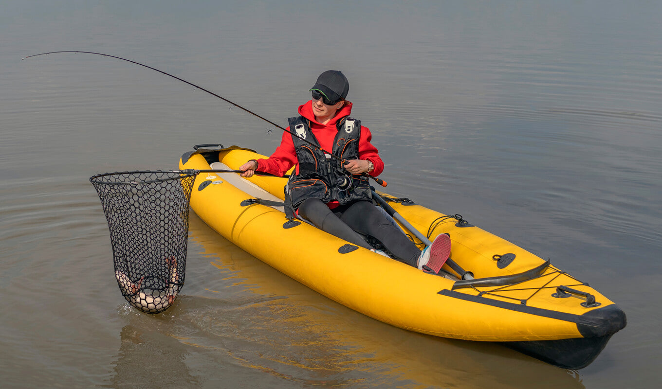 Woman caught a fish while on yellow inflatable paddle board