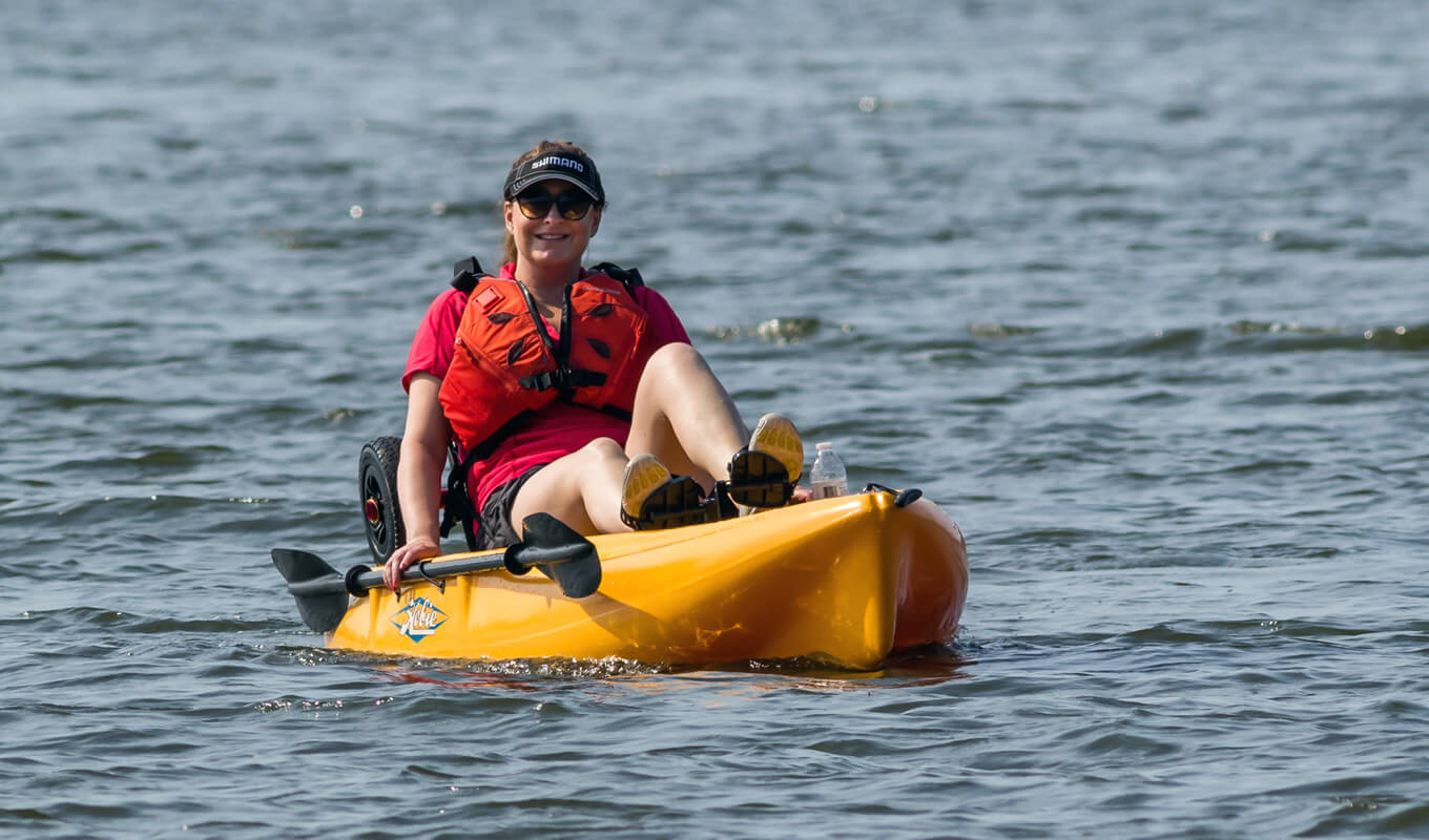 Woman on a yellow pedal kayak