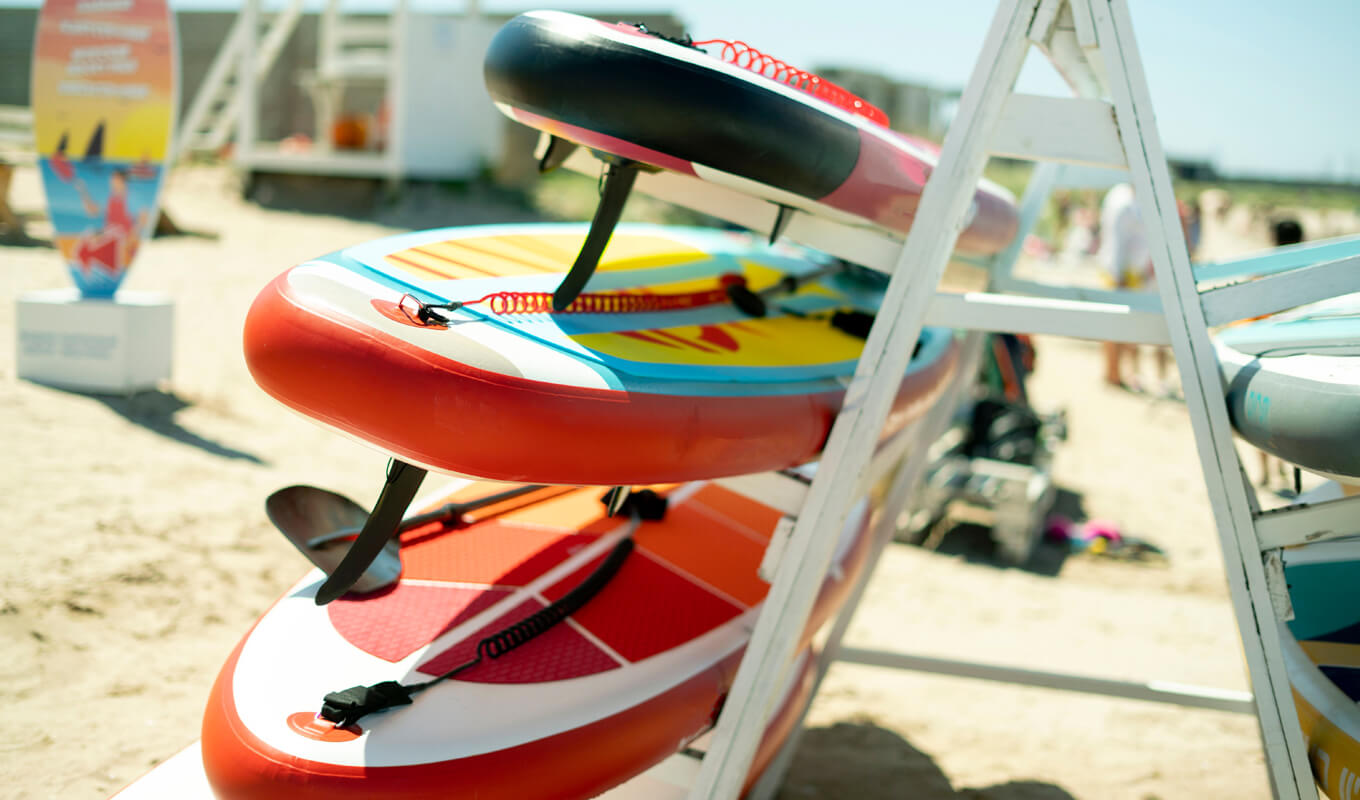 Inflatable paddle boards on a storage racks