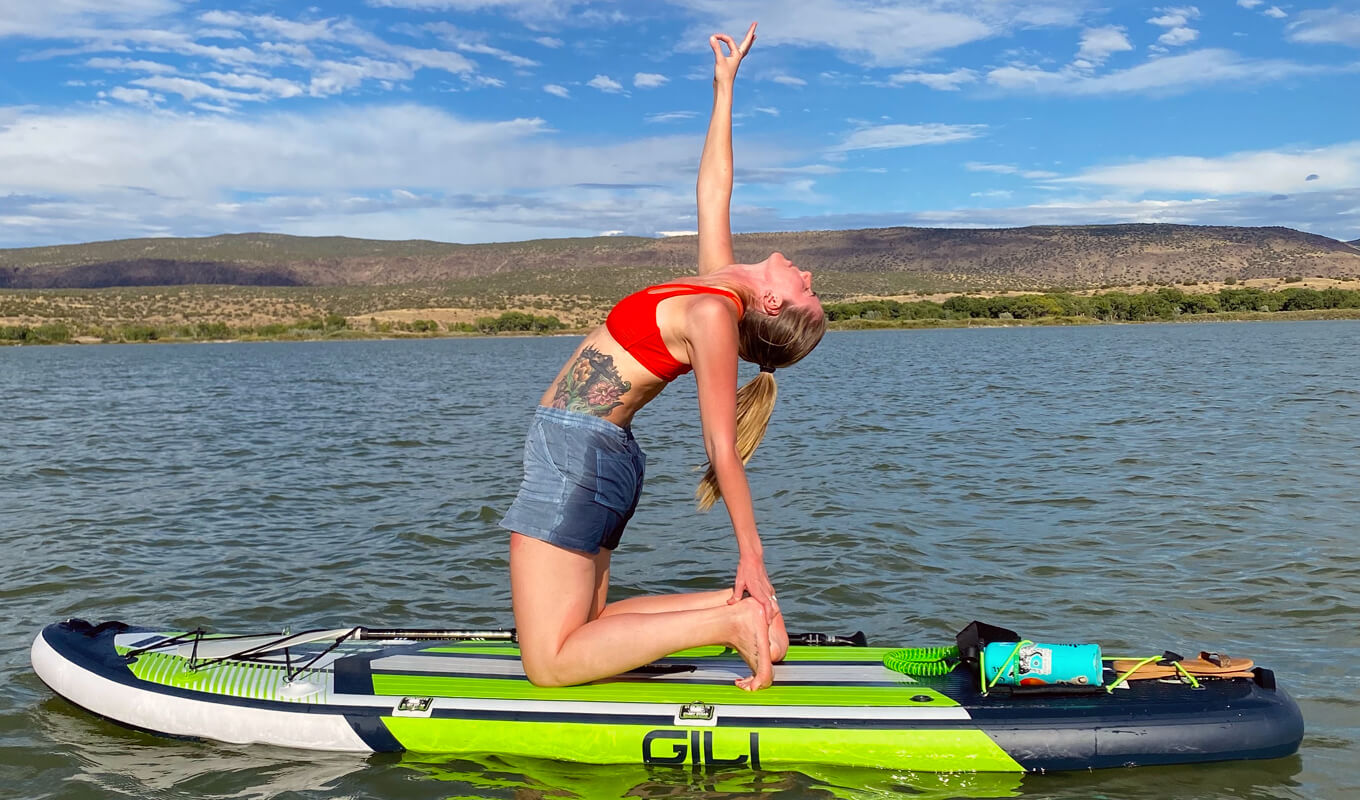 Woman performing a yoga pose on a mako inflatable paddle boards