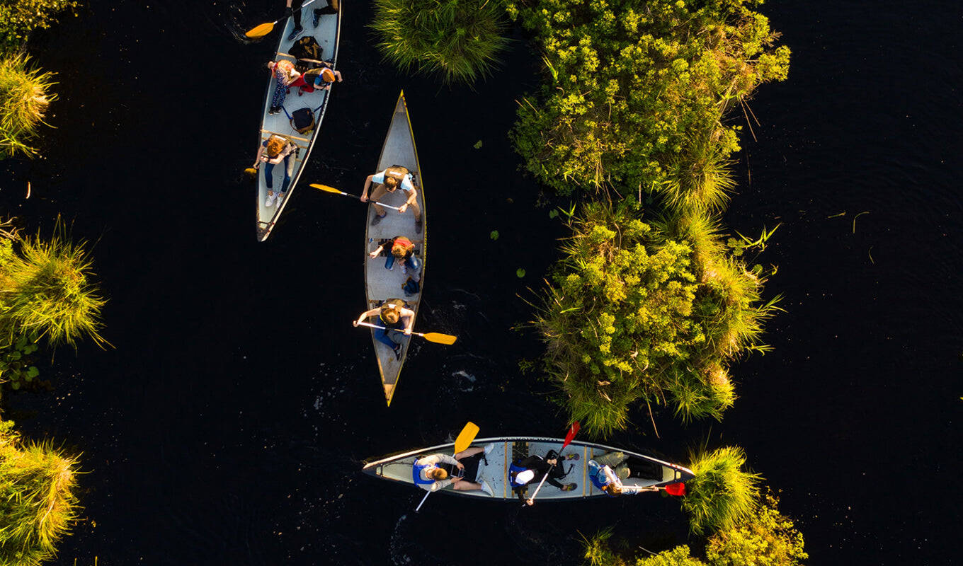 Group of people canoeing on a river