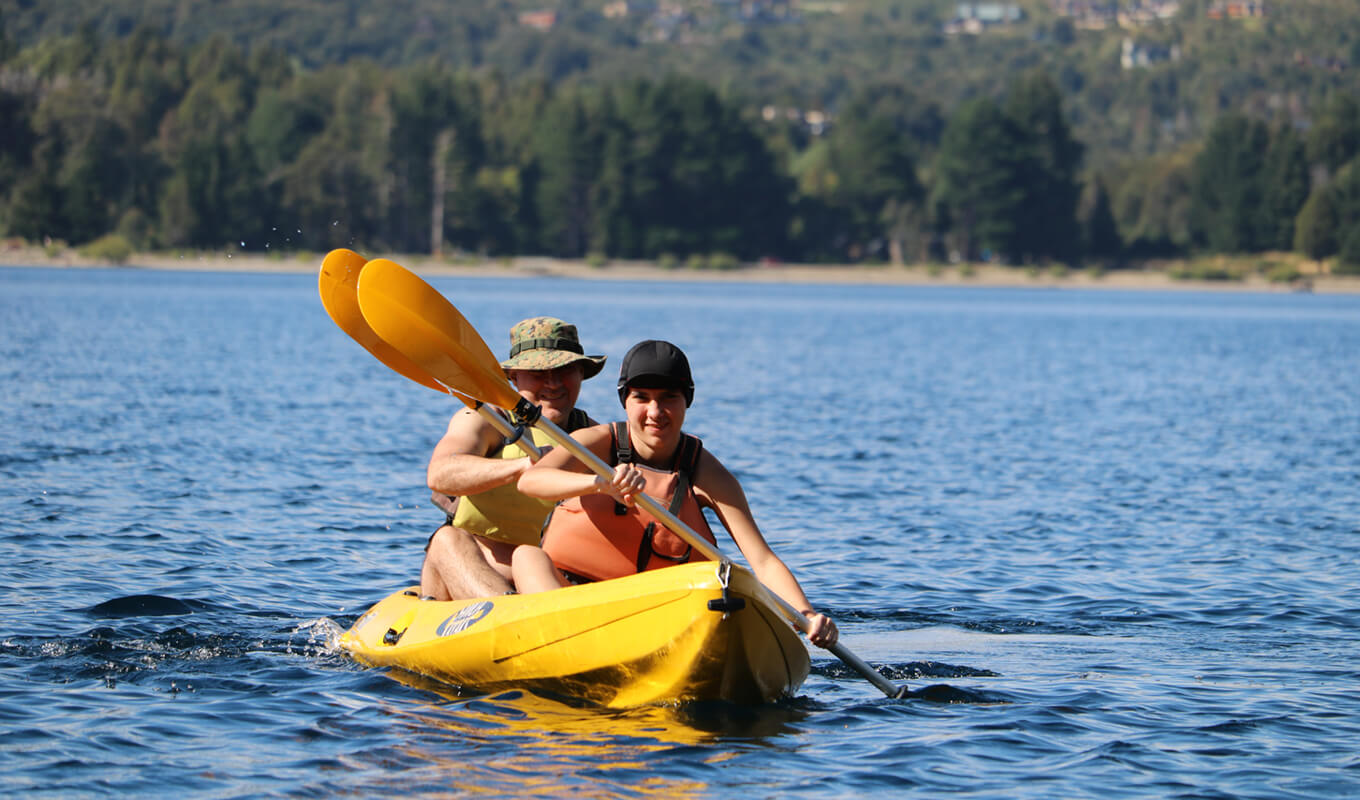 Man and a woman on a yellow sit-on top tandem kayak