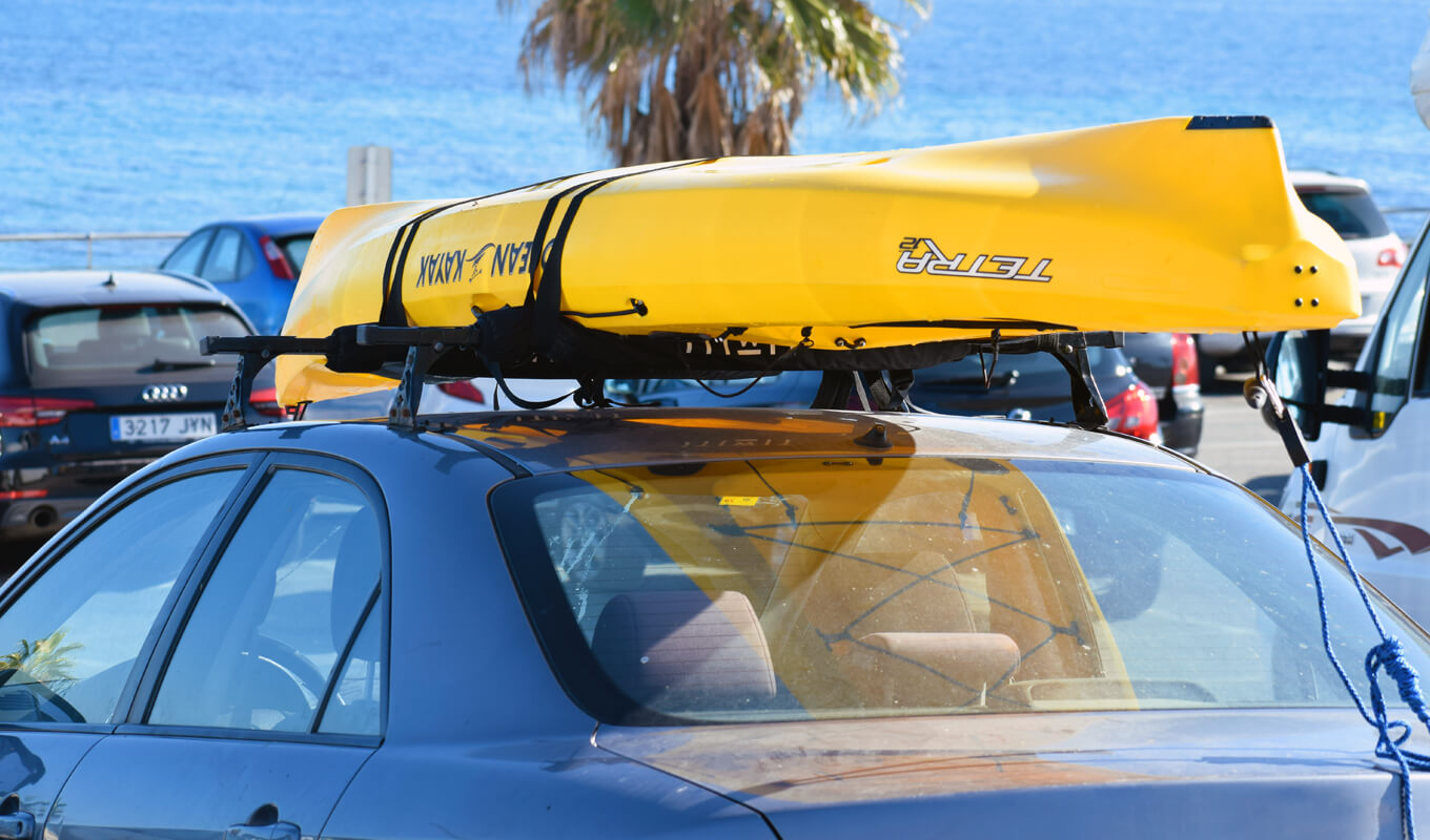 Yellow kayak on a car roof rack