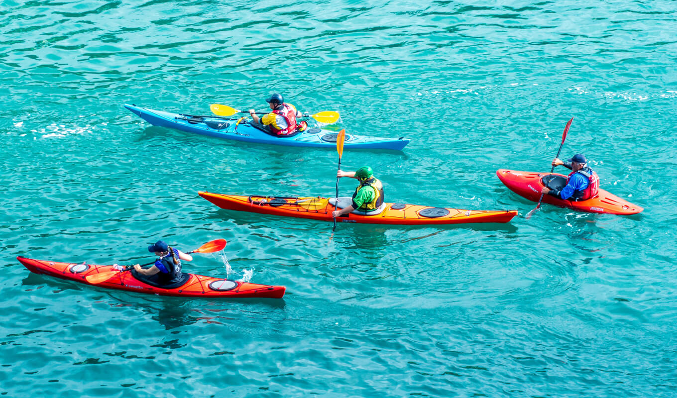 Group of kayakers on a different types of kayak