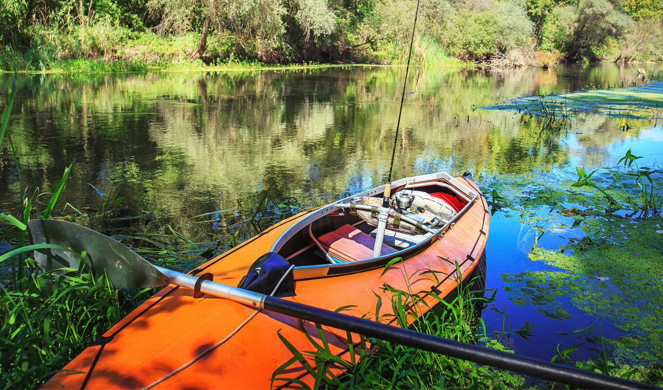 Red inflatable kayak on a lake