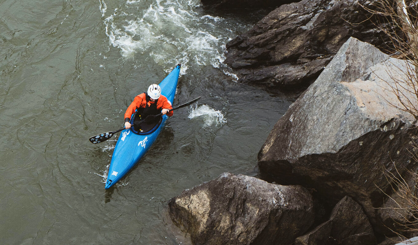 Man kayaking down a river