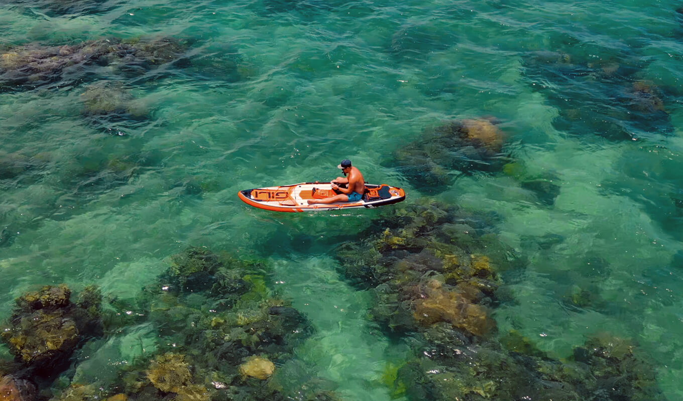 Man paddle boarding in ocean