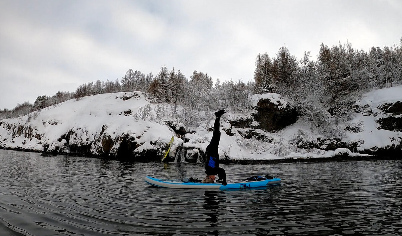 Woman performing yoga on a paddle board in Iceland