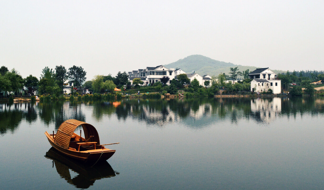 Brown wooden boat on a lake