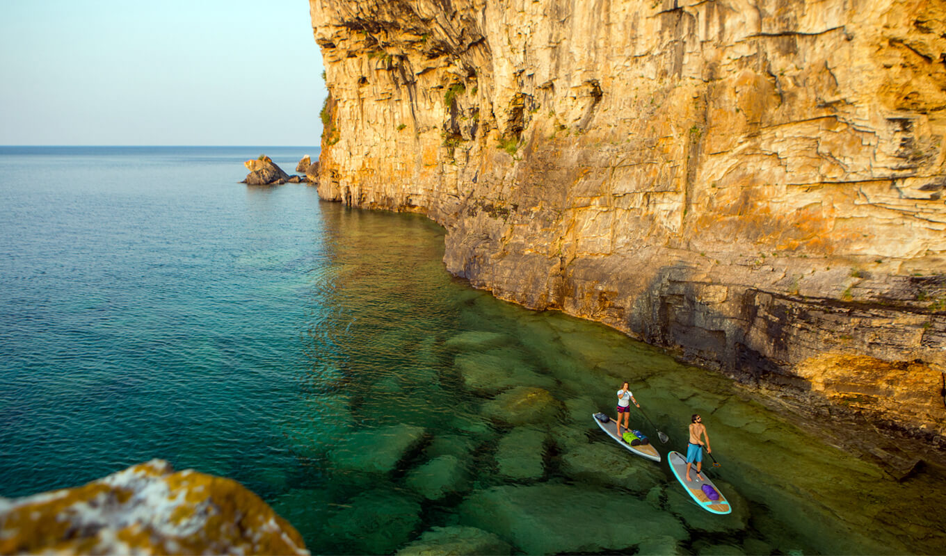 Attractive Young couple Stand Up Paddle Boarding, Ontario Canada