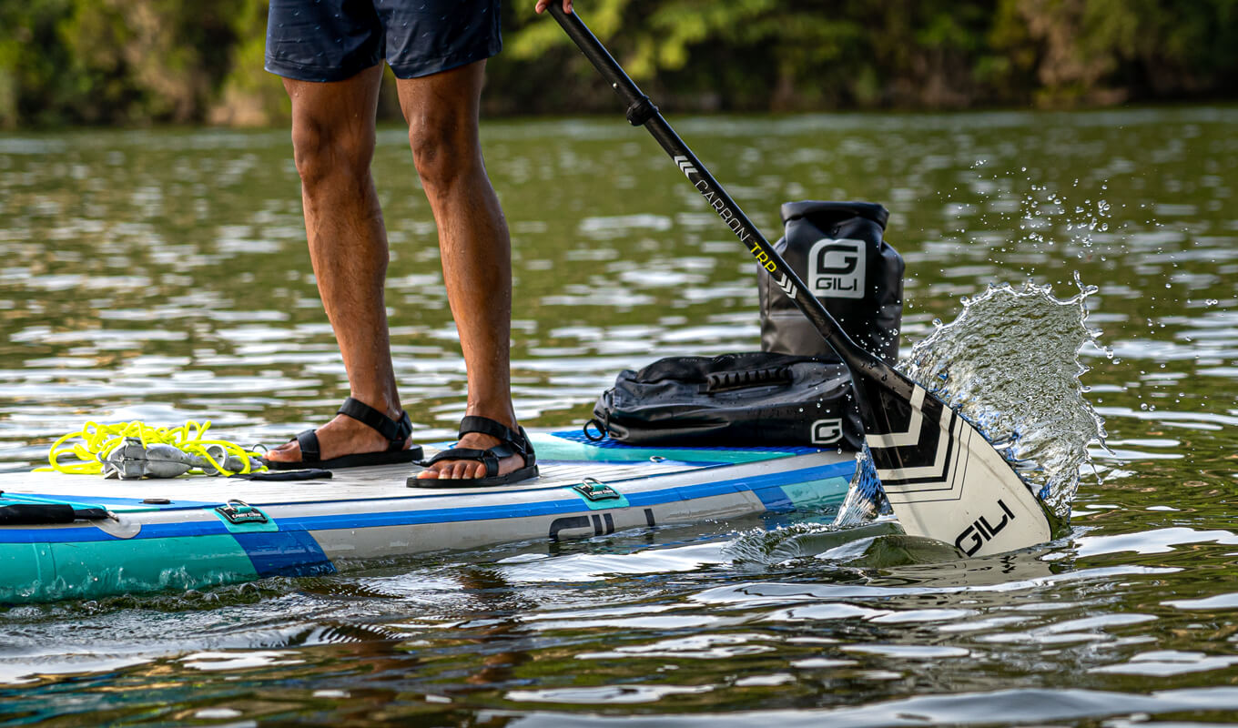 Man paddle boarding on a forward stroke