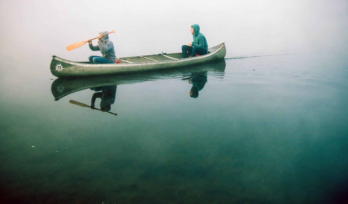 Two man on a green canoe