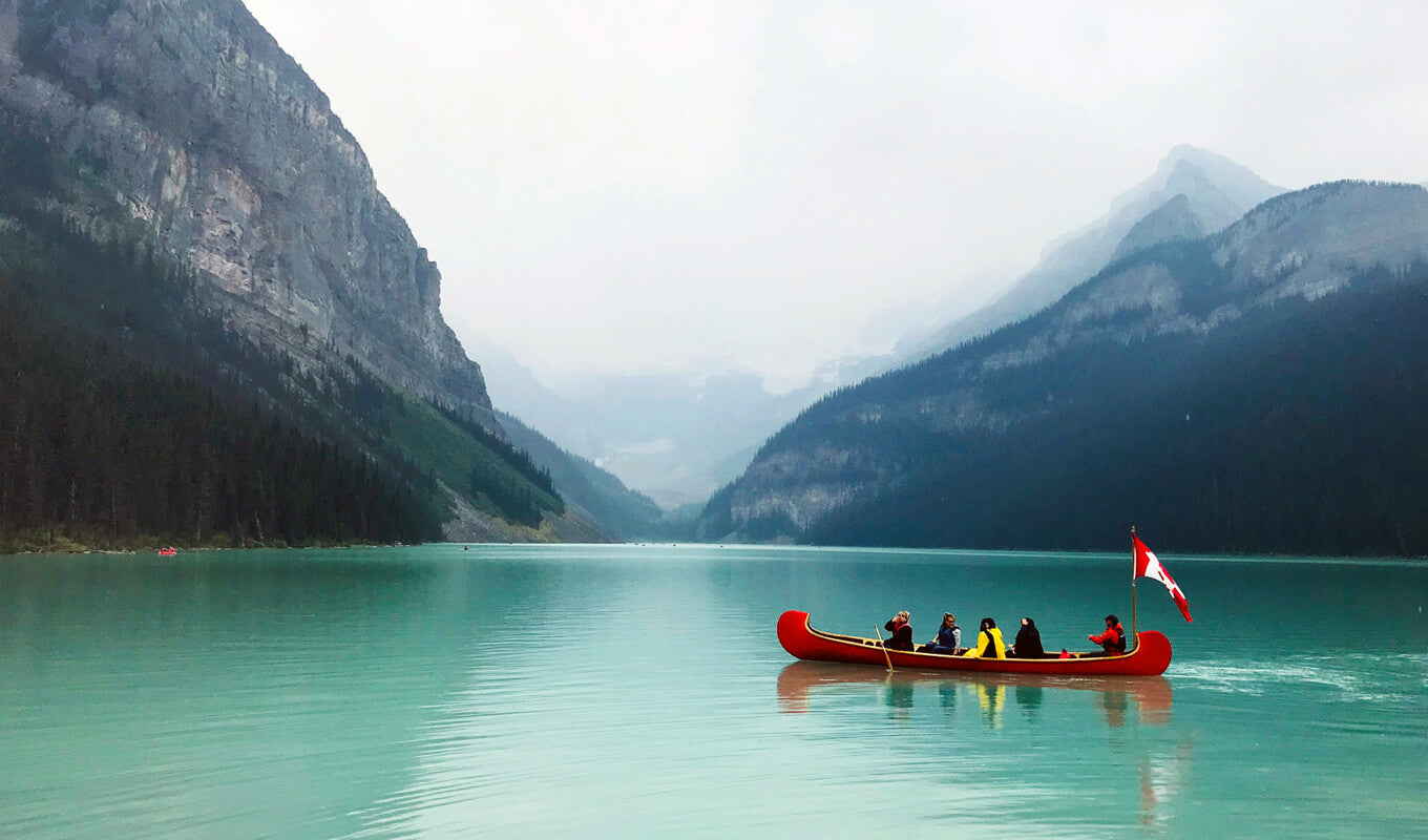 Group of people on a large red canoe