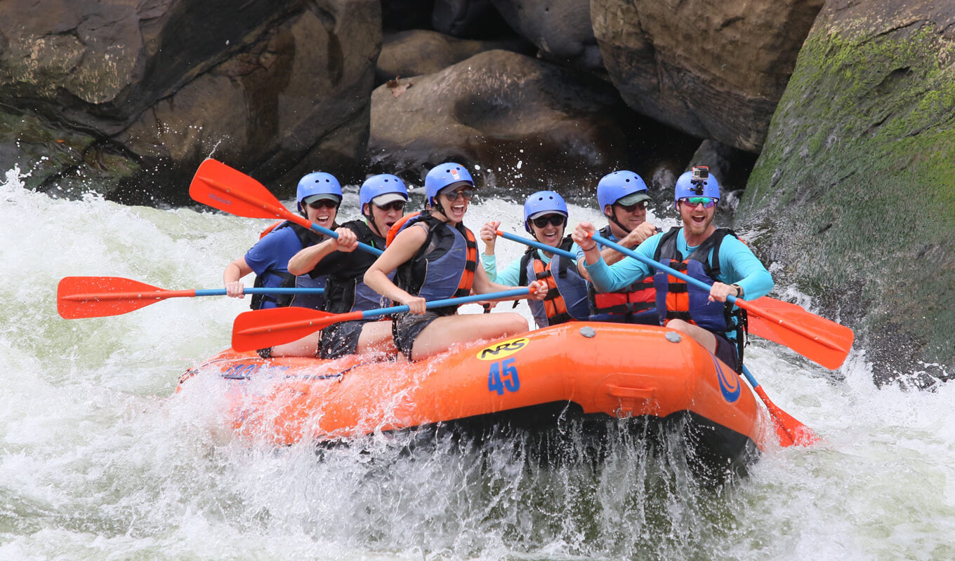 Group of people whitewater rafting