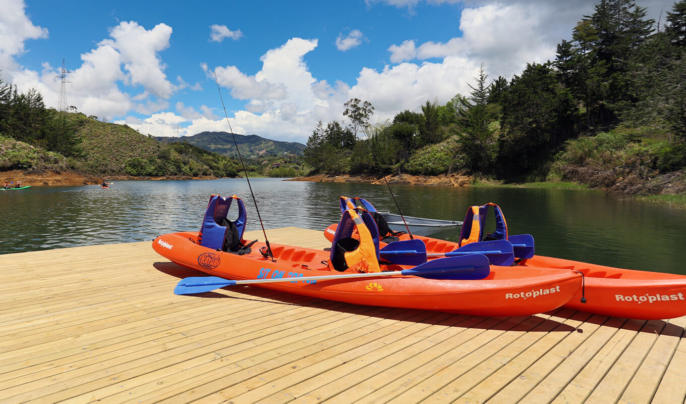 Orange sit on top kayak with a fishing gear