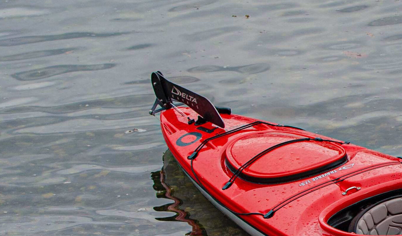 Red sit in kayak with a black rudder