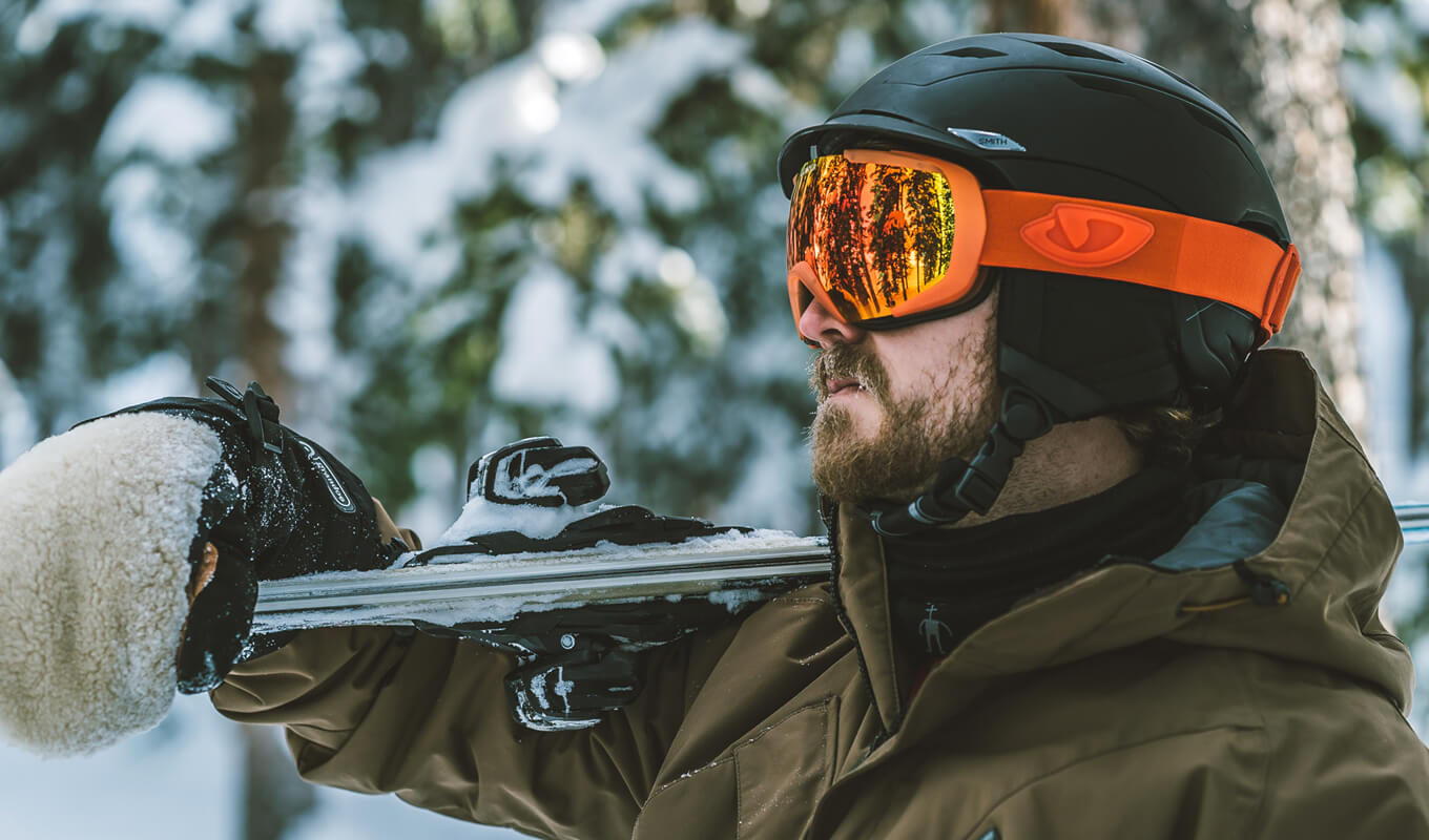 Man wearing a orange snow boarding goggles
