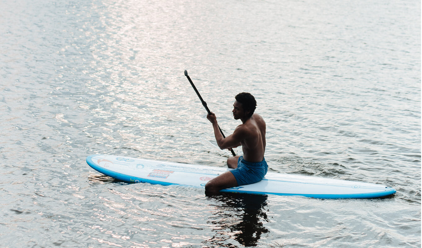 A beginner paddler on a lake