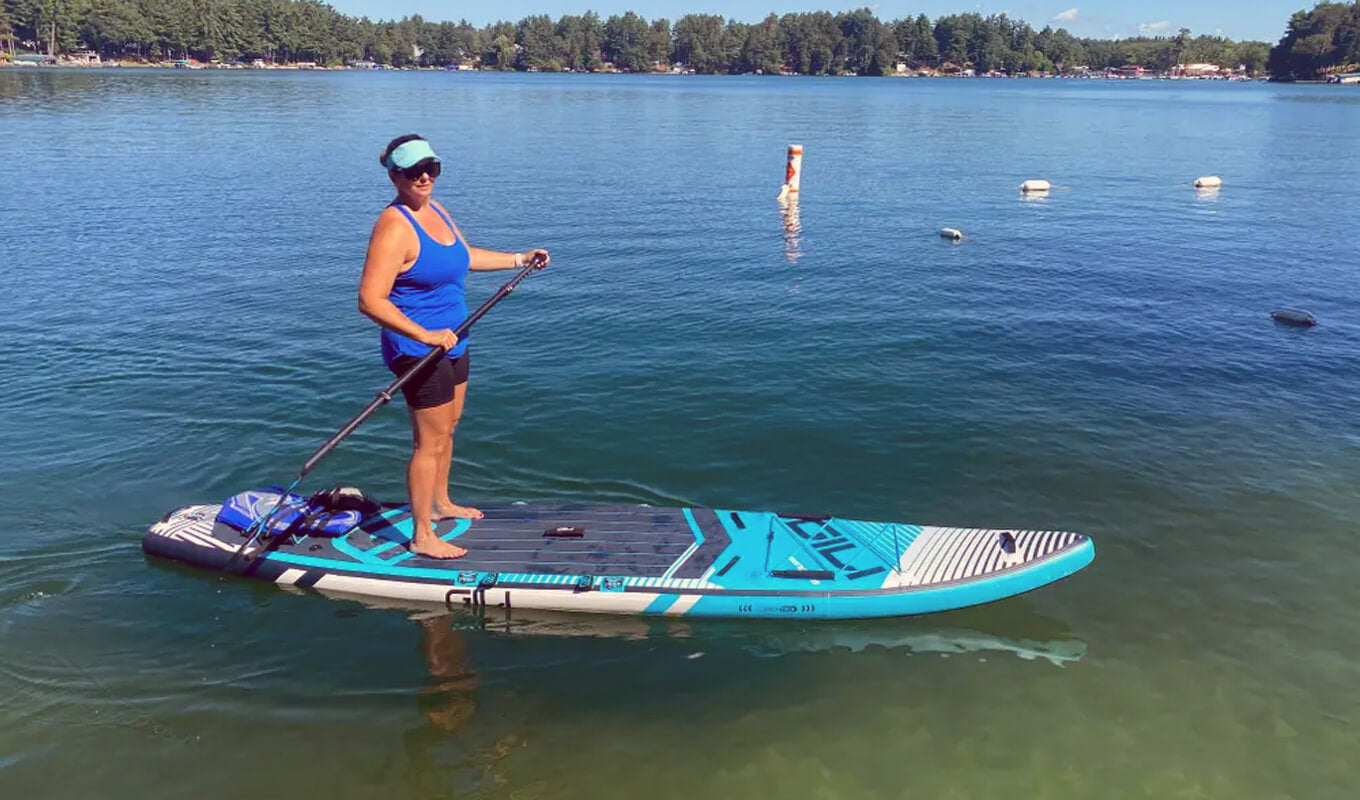 Woman paddle boarding on a Meno touring paddle board