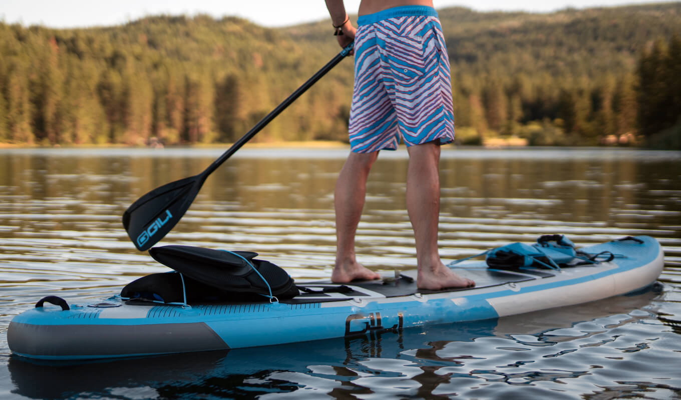 Man paddle boarding with accessories