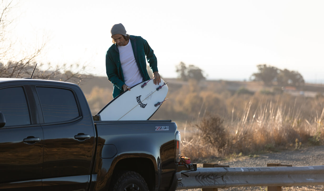 Man transporting his boards on a pickup truck with tailgate rack