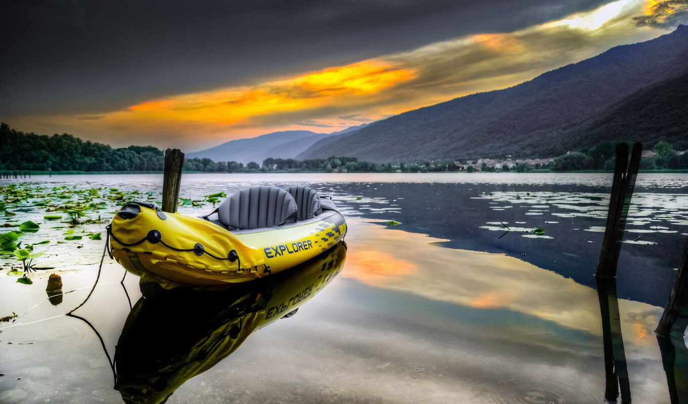 Yellow inflatable tandem kayak on a lake