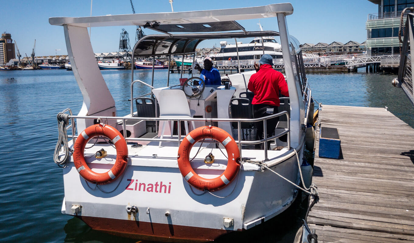 White boat with two red life buoy