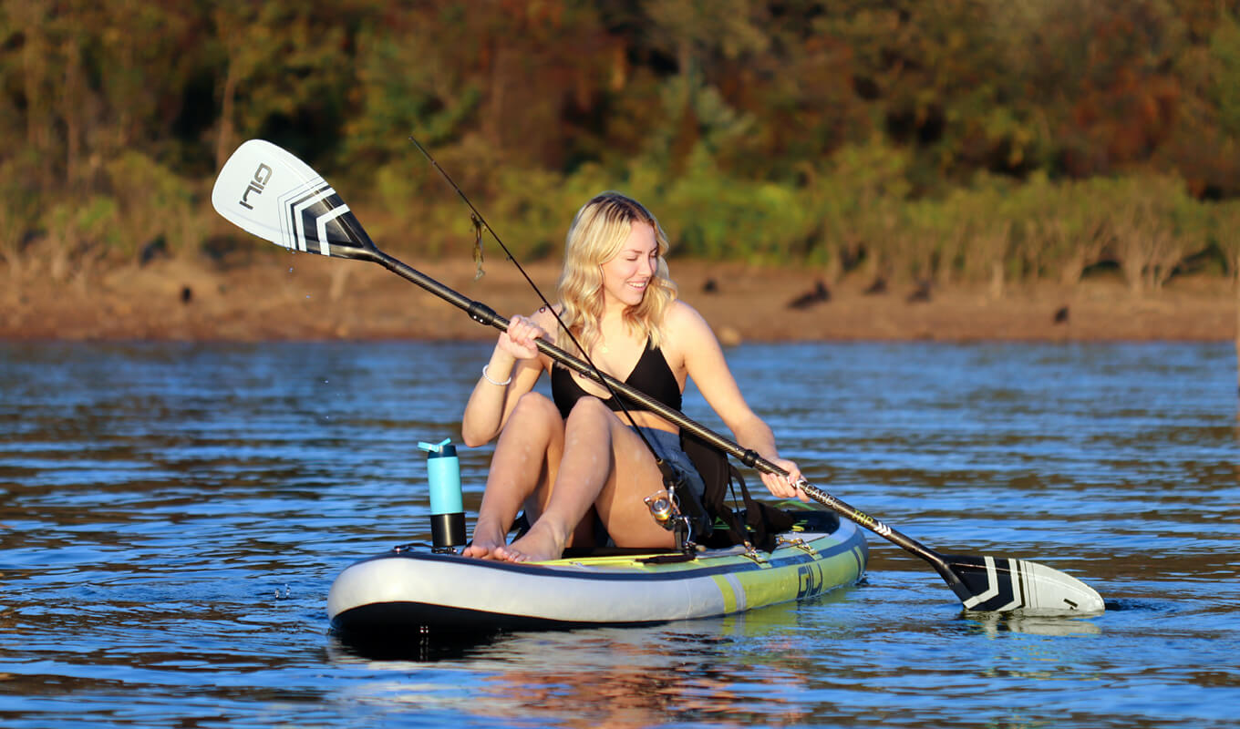 Woman converts her paddle board into a kayak with fishing accessories