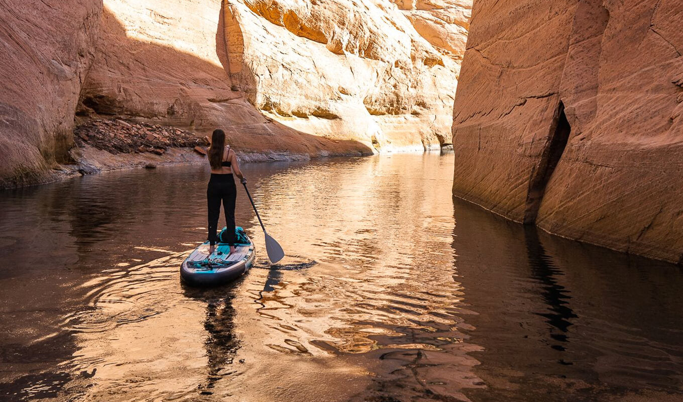 Woman paddling with GILI inflatable paddle board