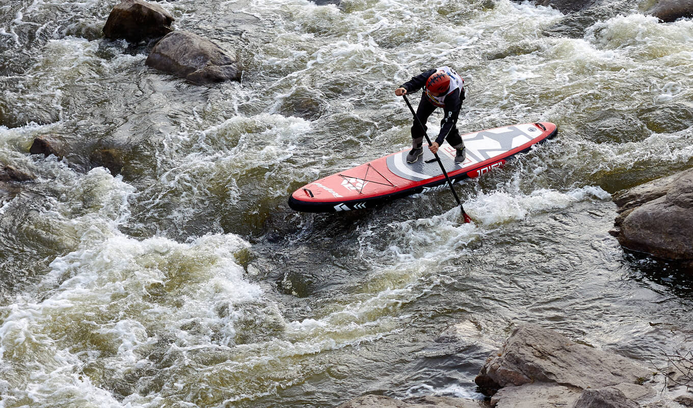 Man paddle boarding on a whitewater