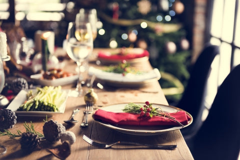 Photograph of a holiday-themed table with plates and napkins.