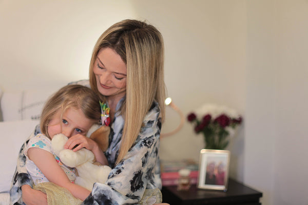 Mum cuddling Daughter