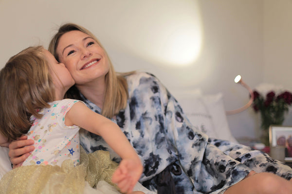 Daughter kissing mum