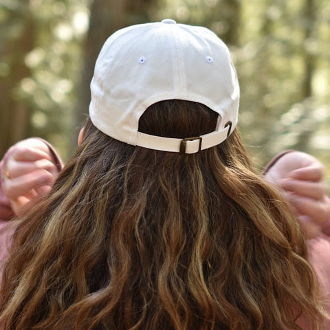 Back of the Shuswap Soul Dad Hat on a lady with lots of hair