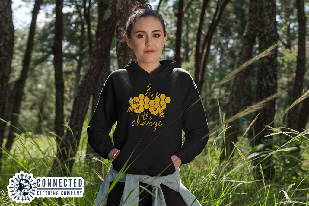 Model Wearing Black Bee The Change Hoodie In A Field - Ethically & Sustainably Made - marktwainstoryteller - 10% donated to The Honeybee Conservancy