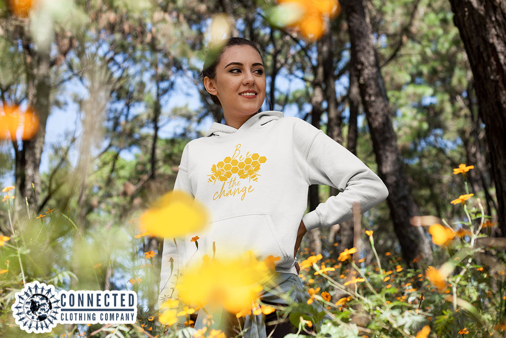 Model Wearing White Bee The Change Hoodie In A Field - Ethically & Sustainably Made - marktwainstoryteller - 10% donated to The Honeybee Conservancy