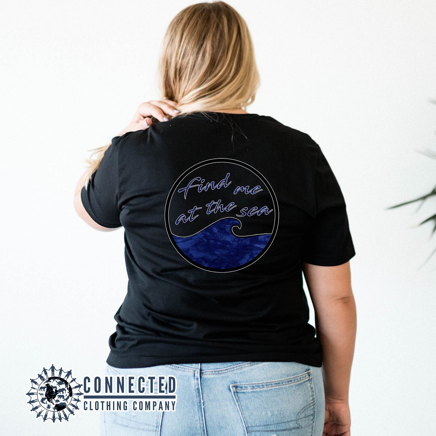 Model Wearing Black Find Me At The Sea Short-Sleeve Tee in front of dock on the water - sweetsherriloudesigns - 10% donated to Mission Blue ocean conservation